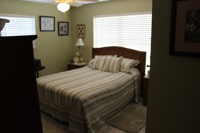 bedroom with multiple windows and ceiling fan