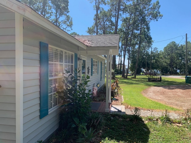 view of side of property with a lawn