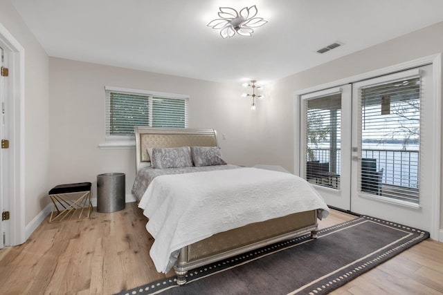 bedroom featuring access to exterior and light hardwood / wood-style flooring