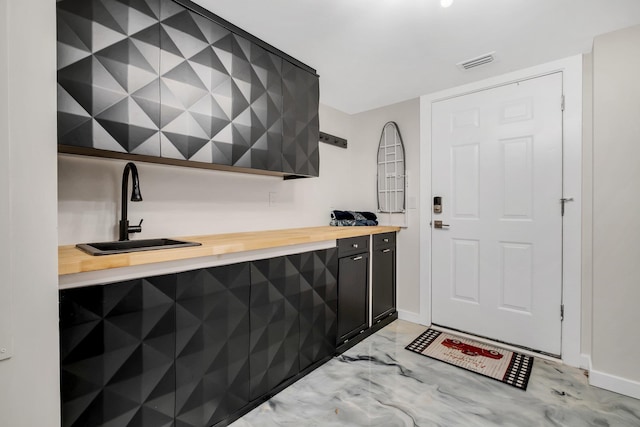 bar with sink and wooden counters