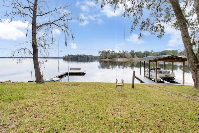 dock area with a water view and a lawn