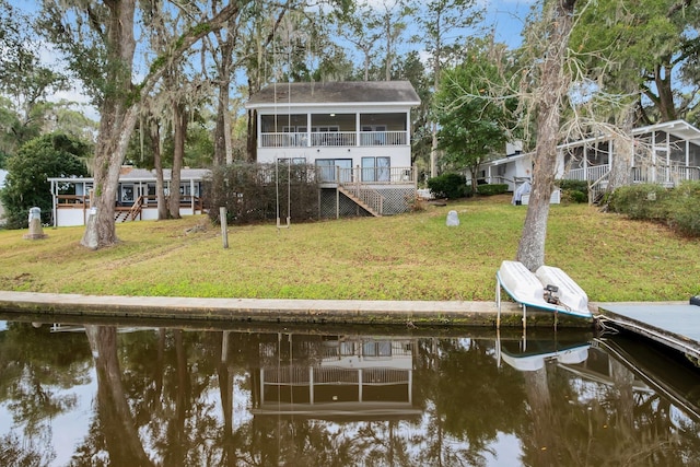 dock area featuring a water view and a lawn