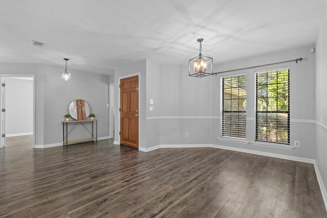 4601 Killimore Ln, Tallahassee, FL 32309 - spare room with a chandelier, dark wood-type flooring, and baseboards