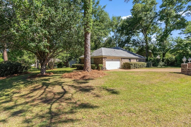 4601 Killimore Ln, Tallahassee, FL 32309 - view of grassy yard with an attached garage and concrete driveway
