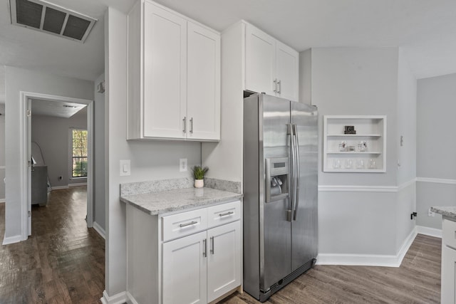 4601 Killimore Ln, Tallahassee, FL 32309 - kitchen featuring stainless steel fridge, dark wood-style floors, white cabinetry, and light stone counters
