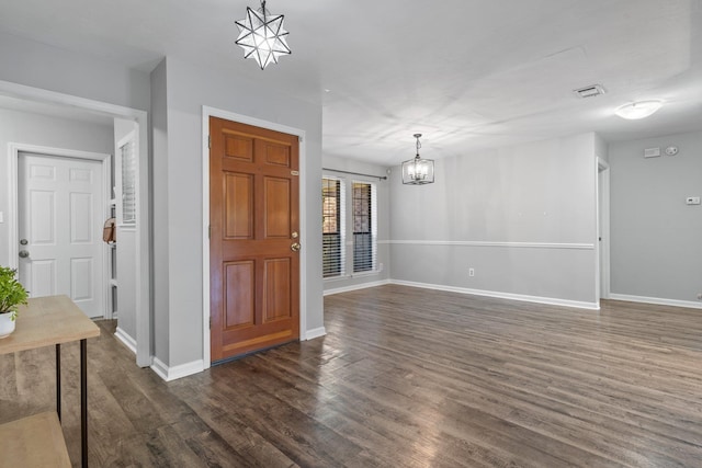 4601 Killimore Ln, Tallahassee, FL 32309 - entryway featuring dark wood-style floors, a chandelier, and baseboards