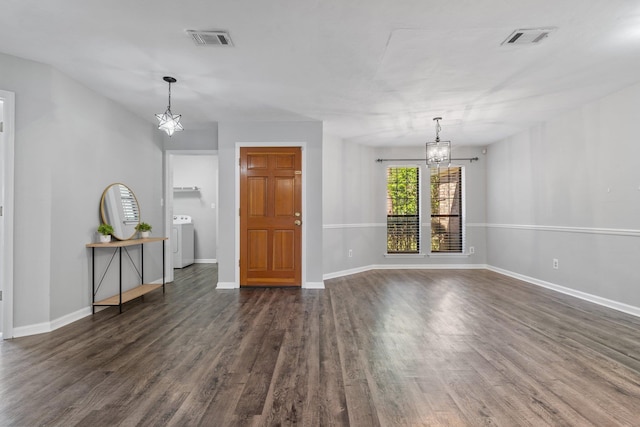 4601 Killimore Ln, Tallahassee, FL 32309 - unfurnished living room featuring a chandelier, washer / clothes dryer, dark wood finished floors, and baseboards