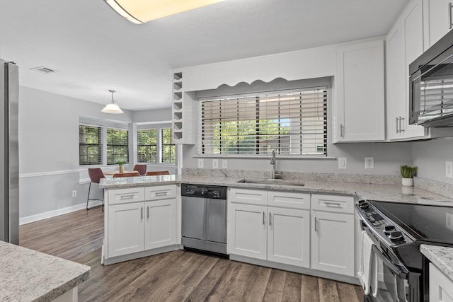 4601 Killimore Ln, Tallahassee, FL 32309 - kitchen with appliances with stainless steel finishes, a sink, white cabinetry, and wood finished floors