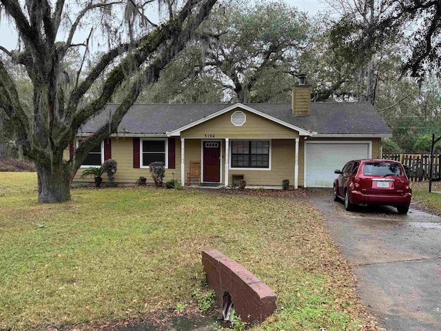 ranch-style home featuring a garage and a front yard