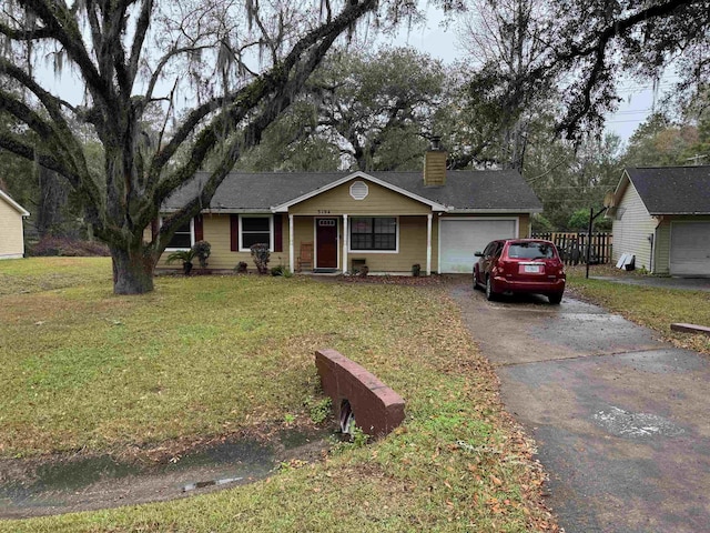 ranch-style home with a front yard and a garage