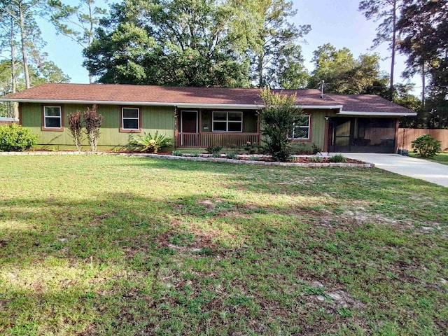 88 Wildwood Dr, Crawfordville, FL 32327 - ranch-style house featuring concrete driveway, an attached carport, and covered porch