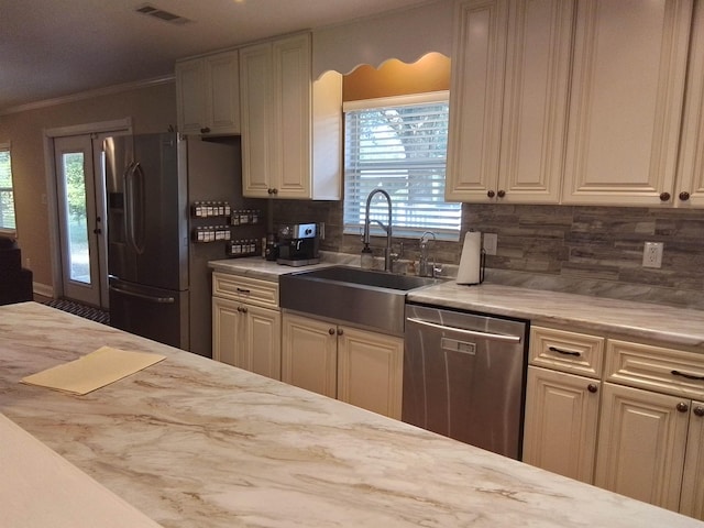 88 Wildwood Dr, Crawfordville, FL 32327 - kitchen featuring stainless steel appliances, tasteful backsplash, and crown molding