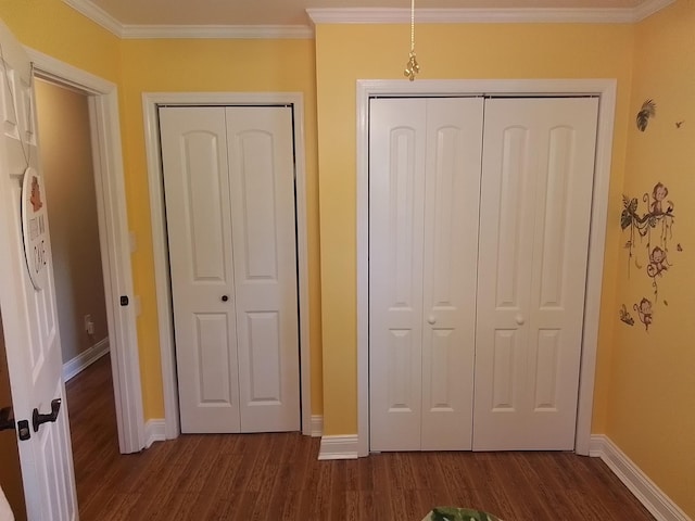 88 Wildwood Dr, Crawfordville, FL 32327 - unfurnished bedroom with dark wood-style floors and ornamental molding