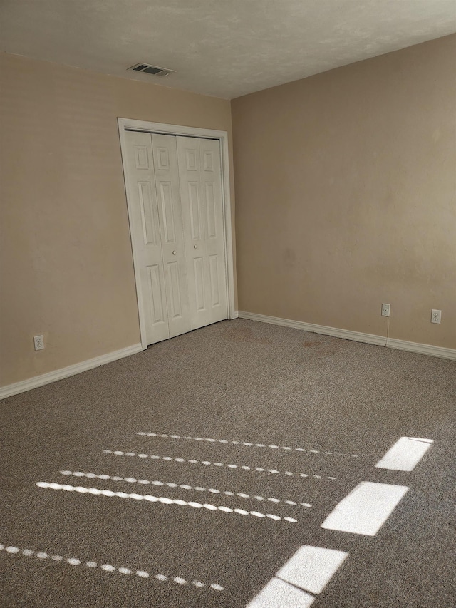 unfurnished bedroom with a closet and carpet