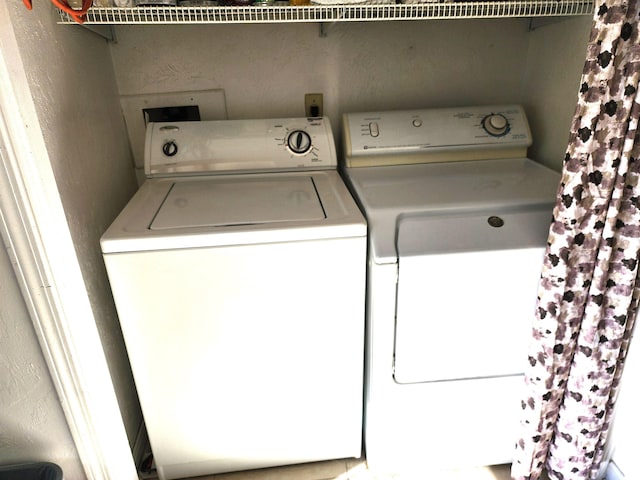 washroom with washing machine and clothes dryer