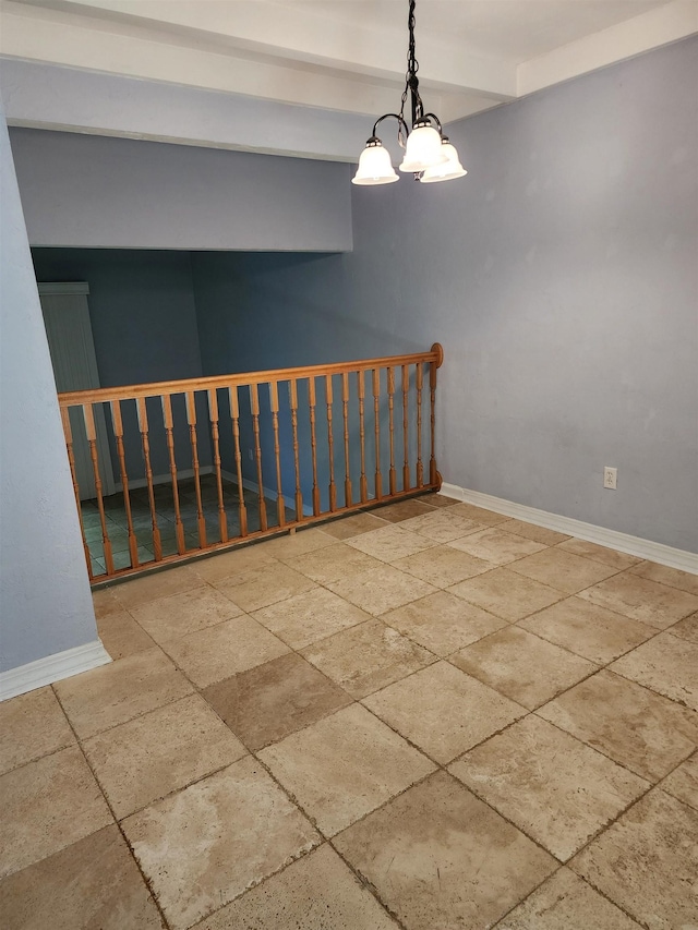 spare room with an inviting chandelier