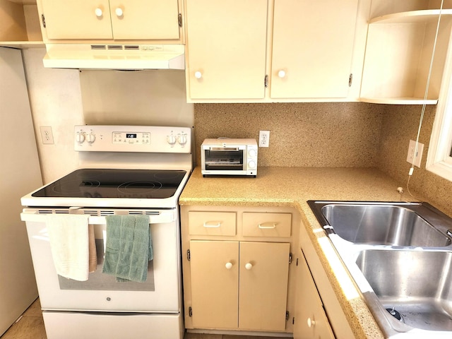 kitchen with white range with electric cooktop, decorative backsplash, sink, light tile patterned floors, and cream cabinetry