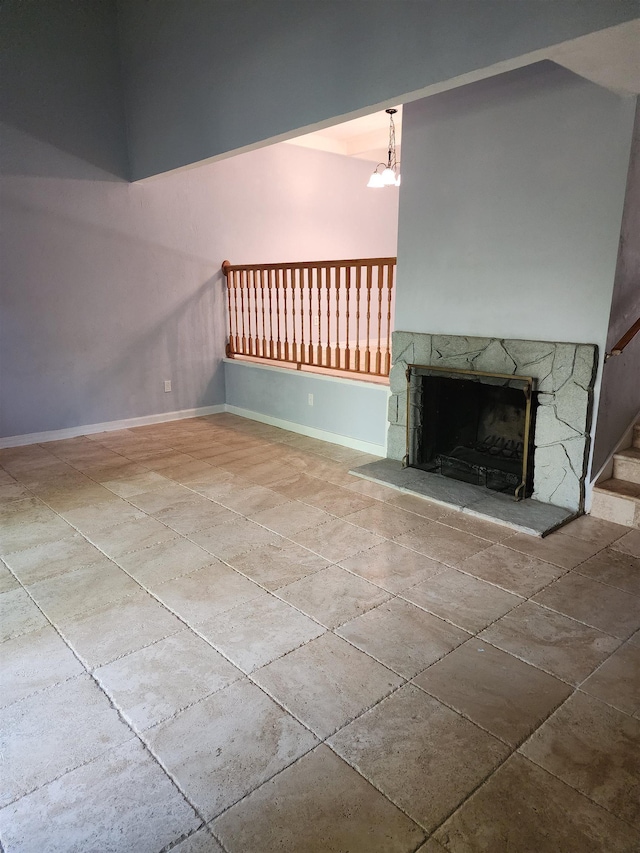 unfurnished living room featuring a fireplace and an inviting chandelier