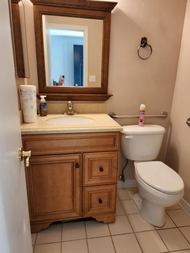 bathroom featuring tile patterned floors, vanity, and toilet