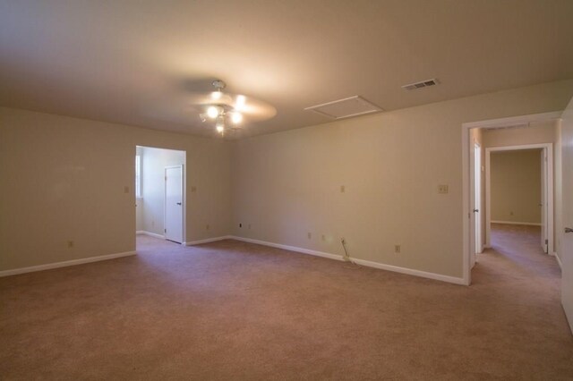 carpeted spare room featuring ceiling fan