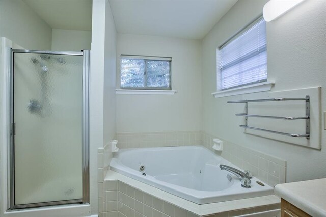 bathroom featuring plenty of natural light, vanity, and separate shower and tub