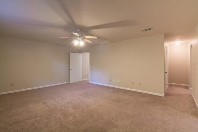 carpeted empty room featuring ceiling fan