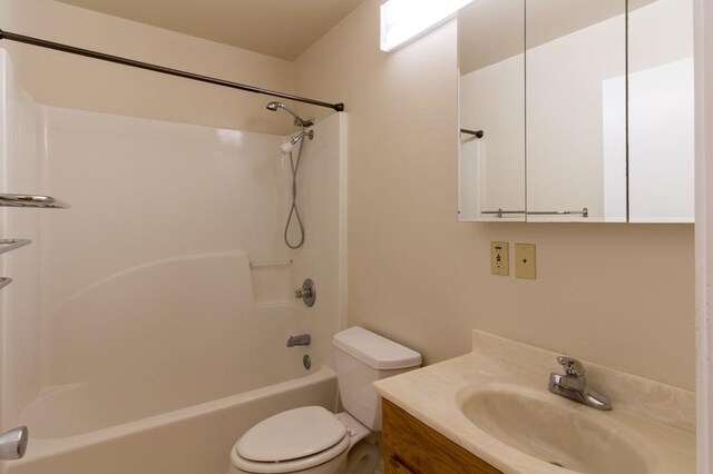 full bathroom featuring toilet, washtub / shower combination, and vanity