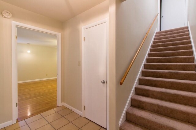 stairs featuring hardwood / wood-style floors