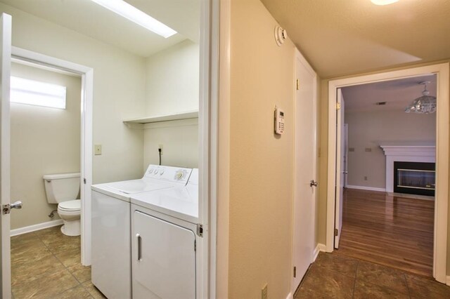 clothes washing area with wood-type flooring and separate washer and dryer