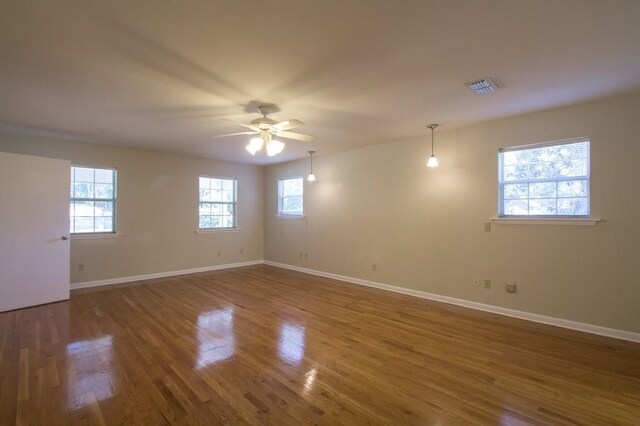 empty room featuring dark hardwood / wood-style floors and ceiling fan