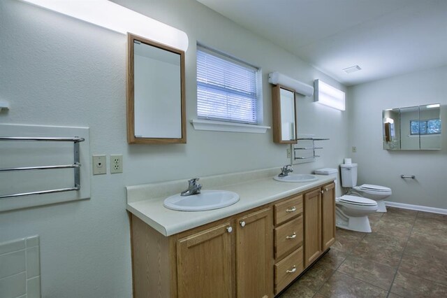 bathroom featuring a bidet, vanity, and toilet