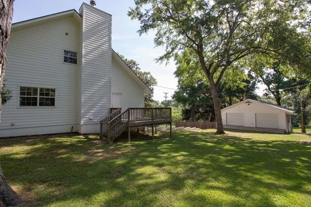 back of property featuring a lawn and a wooden deck