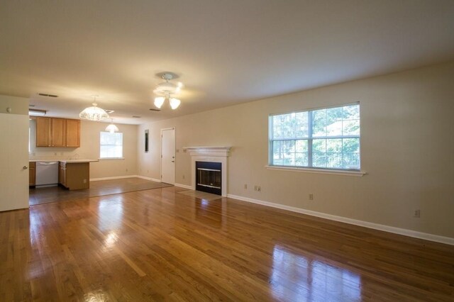 unfurnished living room with ceiling fan and dark hardwood / wood-style floors