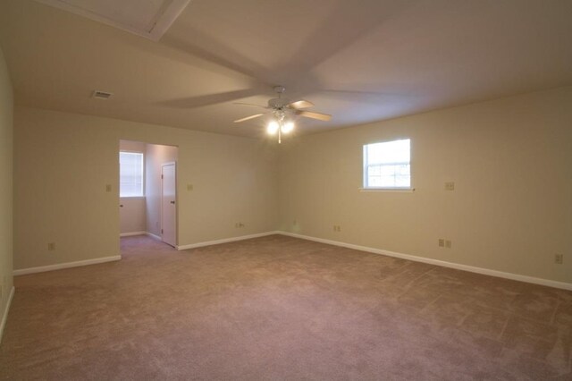 carpeted spare room featuring ceiling fan