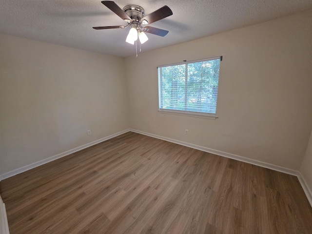 9369 Buck Haven Trl, Tallahassee, FL 32312 - empty room featuring wood finished floors, a ceiling fan, and a textured ceiling