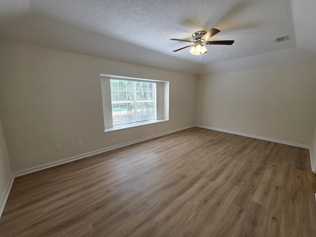 9369 Buck Haven Trl, Tallahassee, FL 32312 - spare room featuring a textured ceiling, wood finished floors, and a ceiling fan