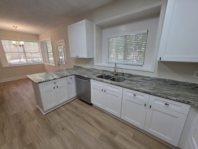 9369 Buck Haven Trl, Tallahassee, FL 32312 - kitchen featuring dishwasher, white cabinets, a peninsula, light wood-style flooring, and a chandelier