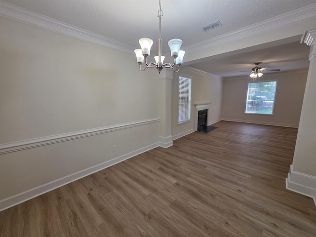 9369 Buck Haven Trl, Tallahassee, FL 32312 - unfurnished living room featuring crown molding, dark wood-style flooring, a fireplace with flush hearth, a chandelier, and ceiling fan