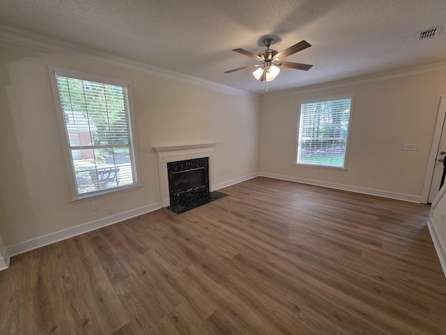 9369 Buck Haven Trl, Tallahassee, FL 32312 - unfurnished living room with healthy amount of natural light, crown molding, dark wood finished floors, ceiling fan, and a premium fireplace