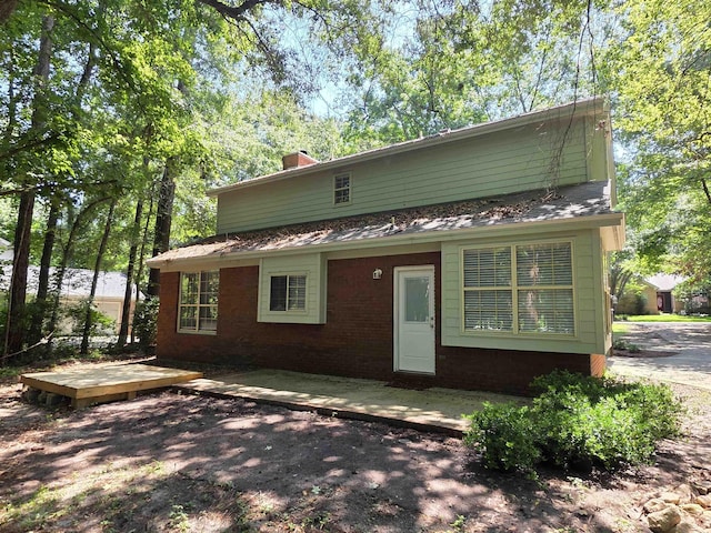 9369 Buck Haven Trl, Tallahassee, FL 32312 - back of house featuring a chimney, a patio, and brick siding