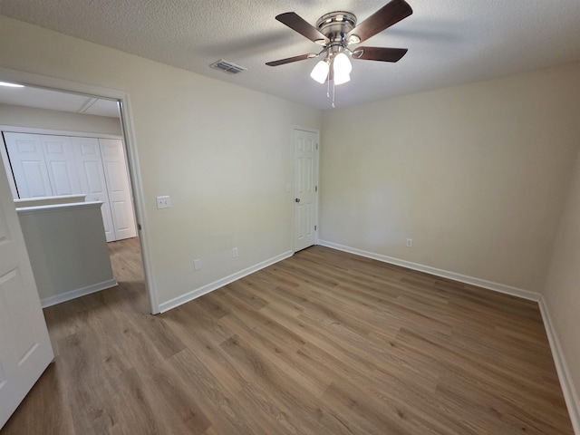 9369 Buck Haven Trl, Tallahassee, FL 32312 - unfurnished bedroom featuring wood finished floors, ceiling fan, and a textured ceiling