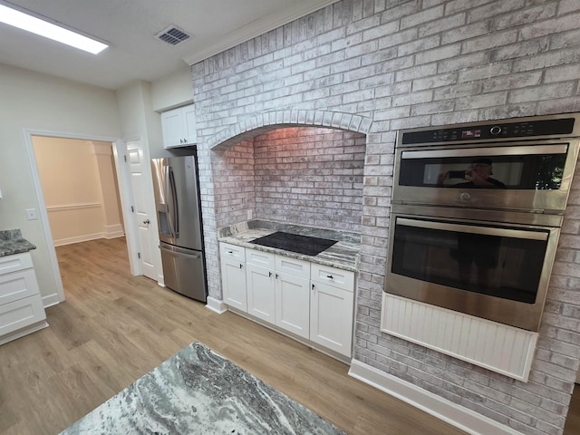 9369 Buck Haven Trl, Tallahassee, FL 32312 - kitchen featuring appliances with stainless steel finishes, light stone countertops, white cabinetry, and light wood finished floors