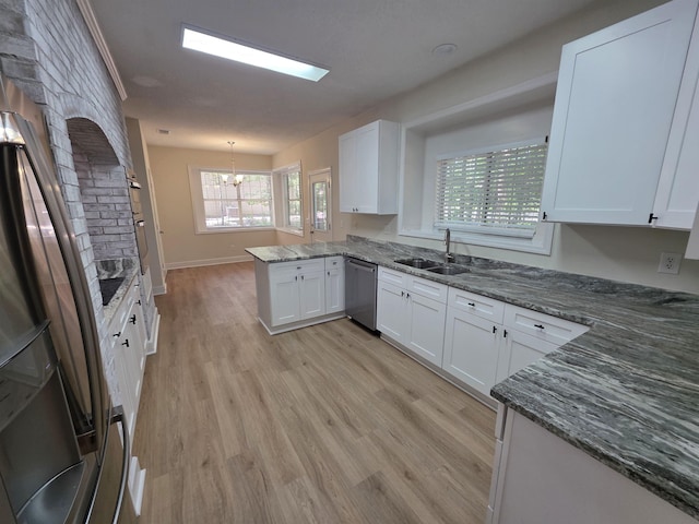 9369 Buck Haven Trl, Tallahassee, FL 32312 - kitchen featuring appliances with stainless steel finishes, a peninsula, a chandelier, and white cabinets