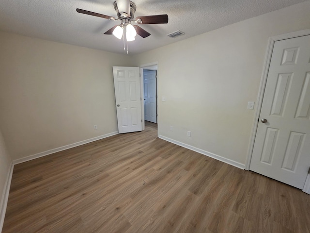 9369 Buck Haven Trl, Tallahassee, FL 32312 - spare room featuring ceiling fan, wood finished floors, and a textured ceiling