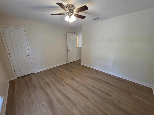 9369 Buck Haven Trl, Tallahassee, FL 32312 - spare room with ceiling fan, wood finished floors, and a textured ceiling