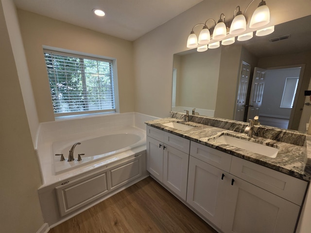 9369 Buck Haven Trl, Tallahassee, FL 32312 - full bathroom featuring double vanity, wood finished floors, a garden tub, and recessed lighting