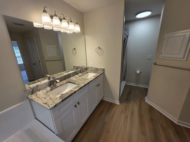 9369 Buck Haven Trl, Tallahassee, FL 32312 - full bathroom with wood finished floors, double vanity, and a shower with shower curtain