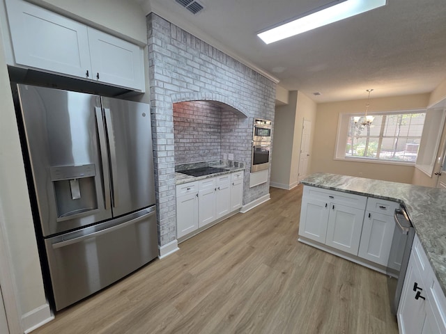 9369 Buck Haven Trl, Tallahassee, FL 32312 - kitchen featuring appliances with stainless steel finishes, light wood finished floors, white cabinetry, a chandelier, and light stone counters