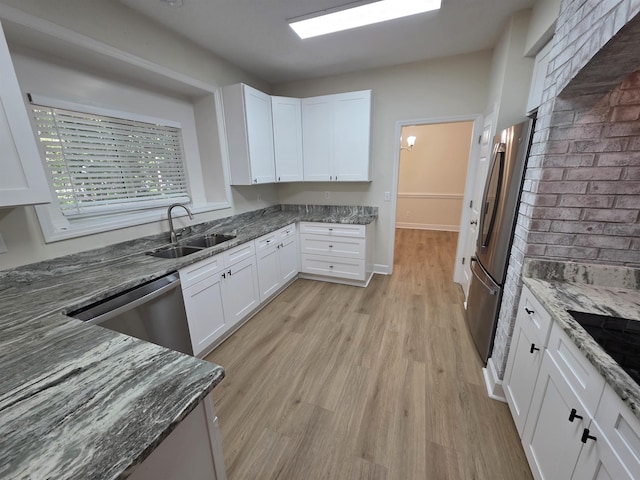 9369 Buck Haven Trl, Tallahassee, FL 32312 - kitchen featuring appliances with stainless steel finishes, dark stone counters, white cabinets, and light wood-style floors