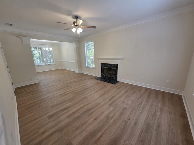 9369 Buck Haven Trl, Tallahassee, FL 32312 - unfurnished living room with crown molding, ceiling fan, wood finished floors, a fireplace, and a chandelier
